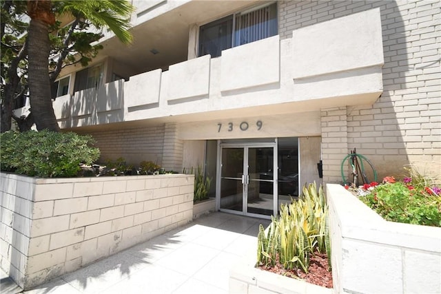 7309 Franklin Ave Unit 105, Los Angeles, CA 90046 - doorway to property with brick siding and french doors