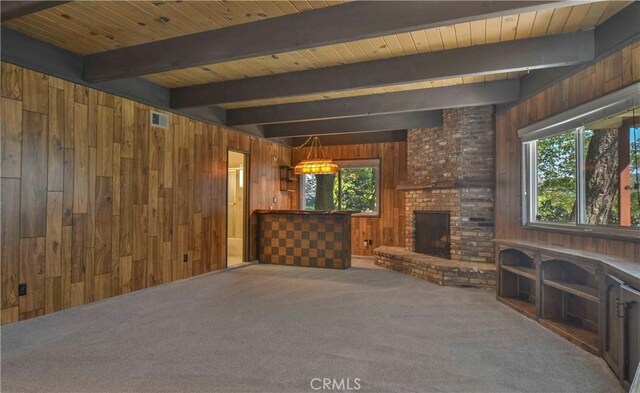 28680 Zion Dr, Lake Arrowhead, CA 92352 - unfurnished living room with wooden walls, healthy amount of natural light, carpet floors, wooden ceiling with exposed beams, and a fireplace
