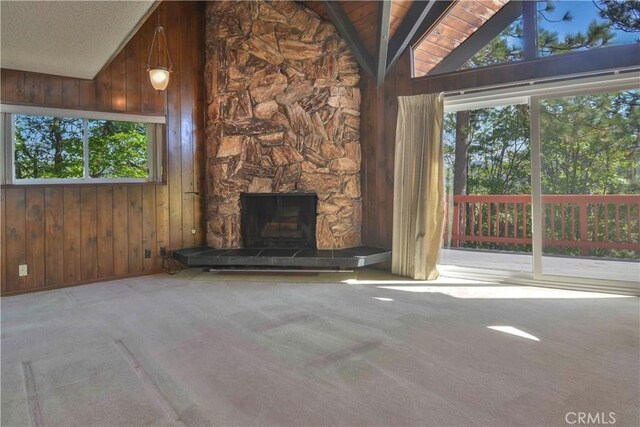 28680 Zion Dr, Lake Arrowhead, CA 92352 - unfurnished living room with wood walls, carpet flooring, and a stone fireplace