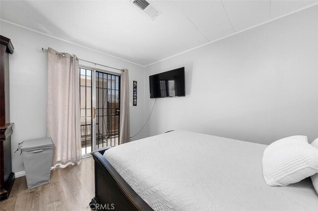 705 Pecos St, Spring Valley, CA 91977 - bedroom with wood finished floors, access to exterior, and crown molding
