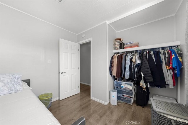 705 Pecos St, Spring Valley, CA 91977 - bedroom featuring wood finished floors, baseboards, crown molding, and a closet