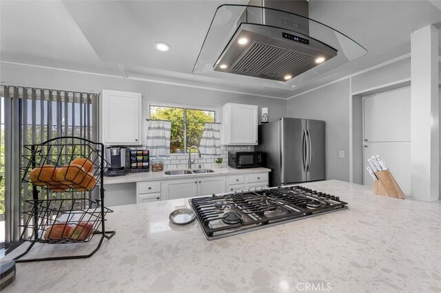705 Pecos St, Spring Valley, CA 91977 - kitchen with stainless steel appliances, a sink, exhaust hood, white cabinets, and backsplash