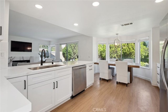 24775 Calle Serranona, Calabasas, CA 91302 - kitchen featuring a sink, stainless steel appliances, white cabinetry, light wood-style floors, and light countertops