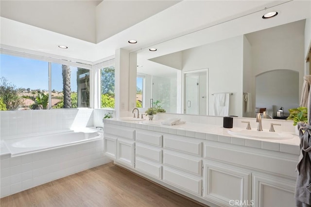 24775 Calle Serranona, Calabasas, CA 91302 - bathroom featuring a bath, double vanity, wood finished floors, and recessed lighting