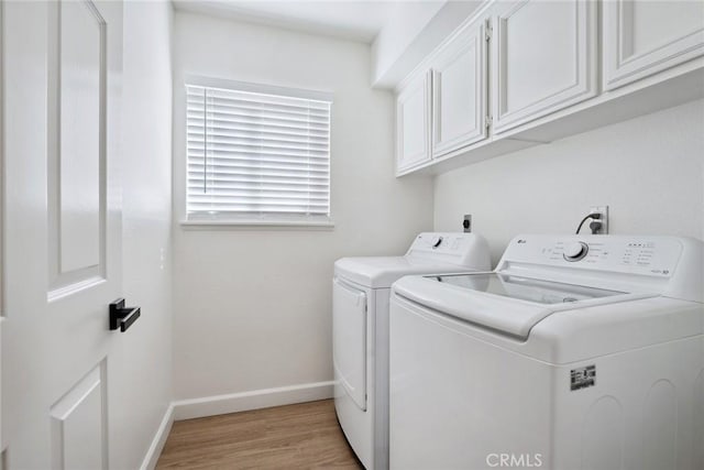 24775 Calle Serranona, Calabasas, CA 91302 - washroom featuring washing machine and clothes dryer, cabinet space, baseboards, and light wood-style floors