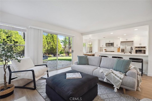 24775 Calle Serranona, Calabasas, CA 91302 - living room with healthy amount of natural light, light wood-style flooring, and recessed lighting