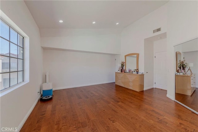 401 W 220th St Unit 40, Carson, CA 90745 - empty room featuring wood finished floors, baseboards, recessed lighting, and a towering ceiling
