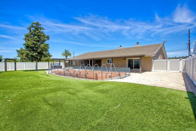 13815 Hilldale Rd, Valley Center, CA 92082 - rear view of house with a patio, a swimming pool, and a chimney