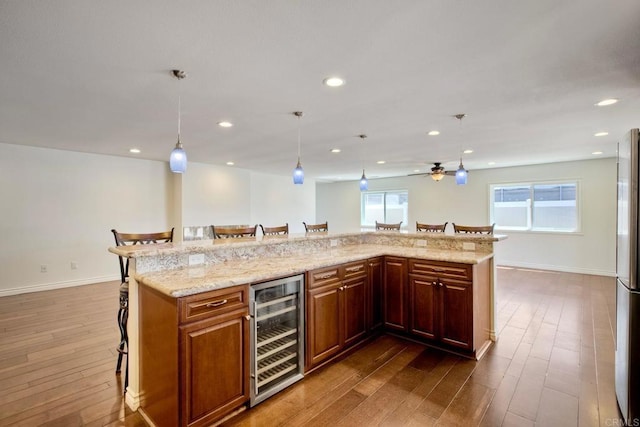 13815 Hilldale Rd, Valley Center, CA 92082 - kitchen featuring wine cooler, a kitchen bar, dark wood finished floors, healthy amount of natural light, and recessed lighting