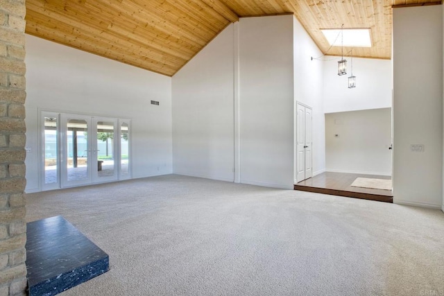 13815 Hilldale Rd, Valley Center, CA 92082 - carpeted empty room with wood ceiling, high vaulted ceiling, french doors, a skylight, and baseboards