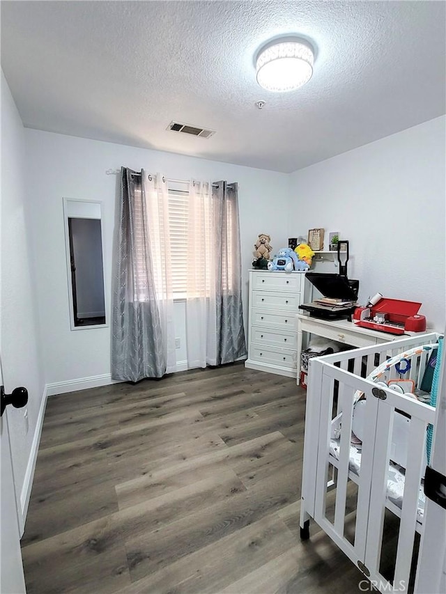 1485 Hansen Ave, Merced, CA 95340 - bedroom featuring a textured ceiling, wood finished floors, and baseboards