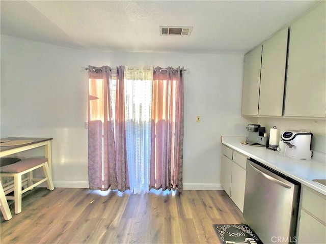 1485 Hansen Ave, Merced, CA 95340 - kitchen featuring dishwasher, light wood-style floors, baseboards, and light countertops