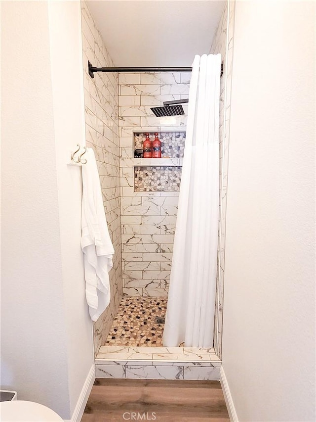 1485 Hansen Ave, Merced, CA 95340 - bathroom with a shower stall, wood finished floors, toilet, and baseboards