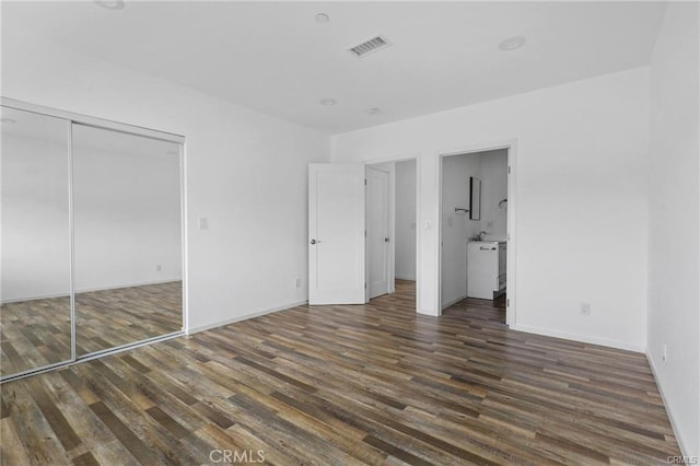 41363/4 Normal Ave Unit 3/4, Los Angeles, CA 90029 - unfurnished bedroom featuring wood finished floors, baseboards, connected bathroom, and a closet