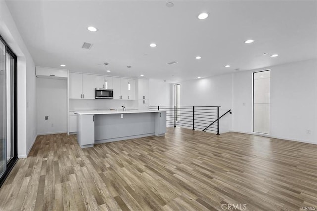 41363/4 Normal Ave Unit 3/4, Los Angeles, CA 90029 - unfurnished living room featuring light wood-type flooring, recessed lighting, a sink, and baseboards