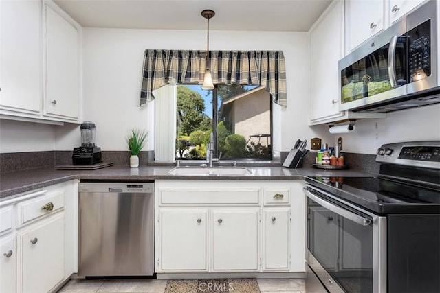 4119 Oak Island Ln, Fallbrook, CA 92028 - kitchen with appliances with stainless steel finishes, a sink, dark countertops, and white cabinets