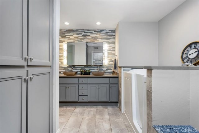 4119 Oak Island Ln, Fallbrook, CA 92028 - full bathroom with recessed lighting, tasteful backsplash, double vanity, and a tub to relax in