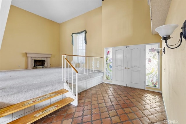 1713 Roanoke St, Placentia, CA 92870 - entryway featuring a high ceiling, stairway, stone finish floors, and a fireplace