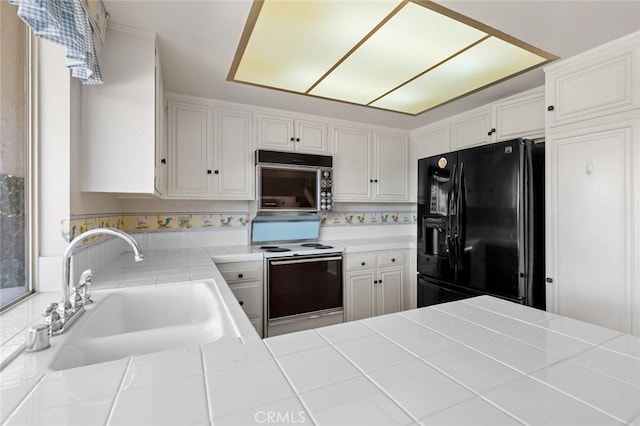 1713 Roanoke St, Placentia, CA 92870 - kitchen featuring black appliances, a sink, tile countertops, and white cabinetry