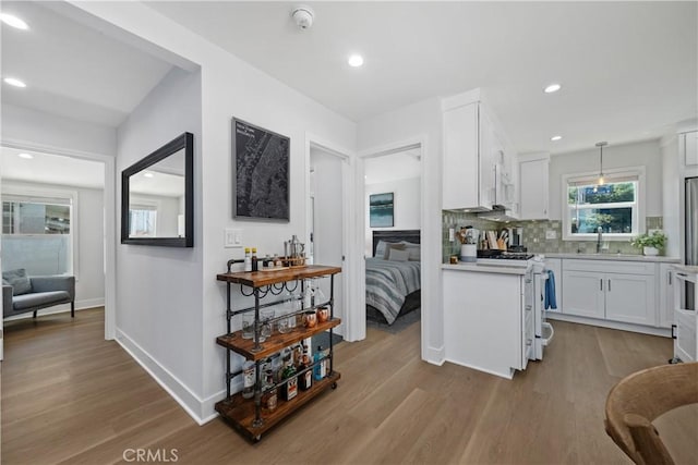 21322 S Western Ave, Torrance, CA 90501 - kitchen featuring gas stove, light countertops, white cabinets, wood finished floors, and recessed lighting
