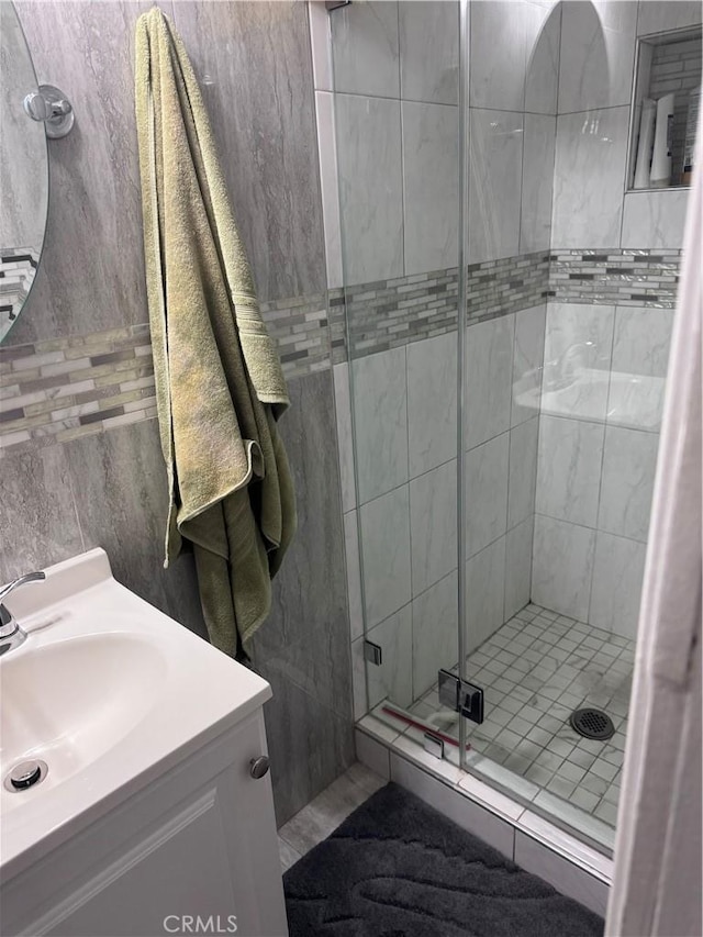 6223 Morse Ave, North Hollywood, CA 91606 - bathroom with a stall shower, vanity, and tile walls