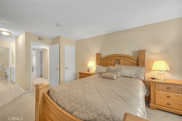 1189 N Sunflower Ave, Covina, CA 91724 - bedroom with light carpet, ensuite bathroom, and baseboards