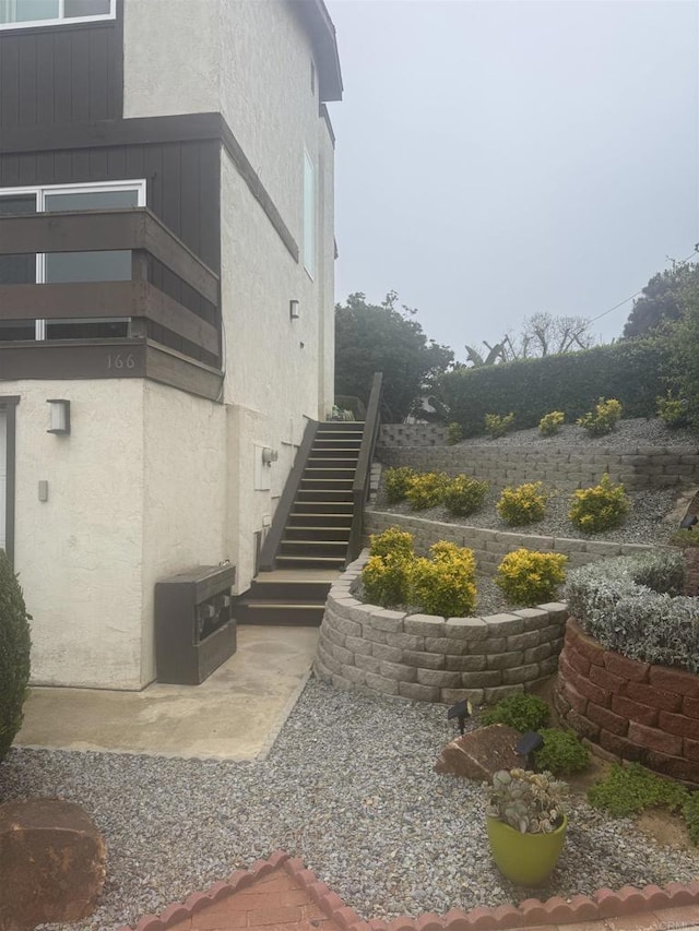 166168 Coop Ct, Encinitas, CA 92024 - view of side of home featuring stairway and stucco siding