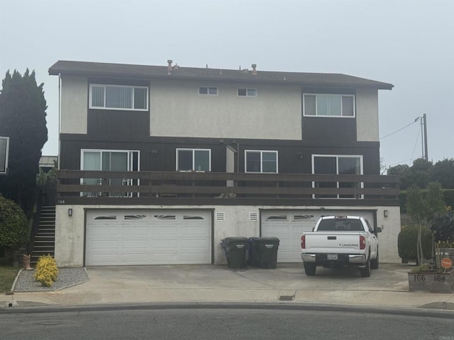 166168 Coop Ct, Encinitas, CA 92024 - rear view of house featuring concrete driveway, a garage, stucco siding, and stairway