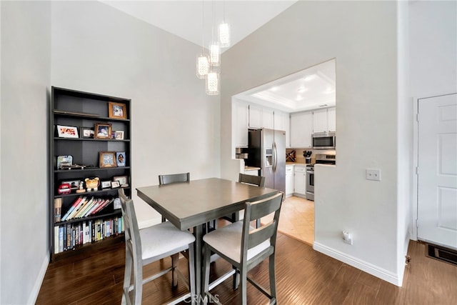 28747 La Triana, Laguna Niguel, CA 92677 - dining space with baseboards, wood finished floors, a chandelier, and a tray ceiling