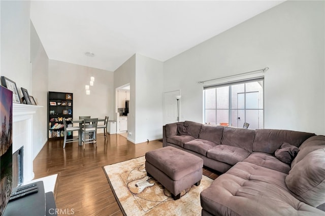 28747 La Triana, Laguna Niguel, CA 92677 - living area featuring a fireplace, wood finished floors, high vaulted ceiling, and baseboards