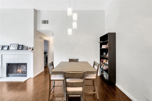 28747 La Triana, Laguna Niguel, CA 92677 - dining area featuring wood finished floors, a high ceiling, a fireplace, and baseboards