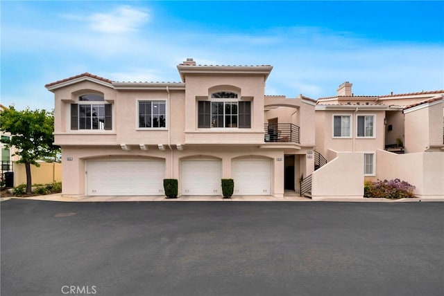 28747 La Triana, Laguna Niguel, CA 92677 - view of front of home with stucco siding, an attached garage, and a tile roof