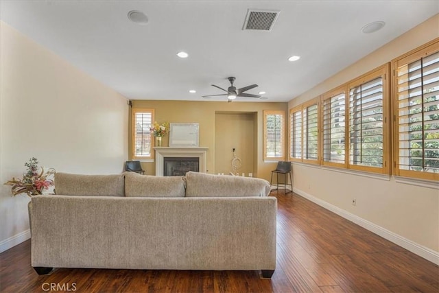 12614 Torrey Pine Rd, Moreno Valley, CA 92555 - living room with baseboards, a glass covered fireplace, dark wood-type flooring, ceiling fan, and recessed lighting