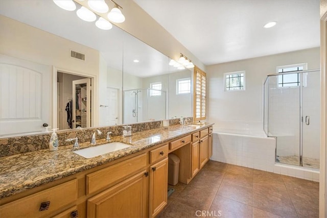 12614 Torrey Pine Rd, Moreno Valley, CA 92555 - full bath with double vanity, a shower stall, a garden tub, a walk in closet, and tile patterned flooring