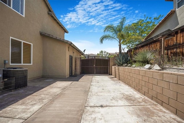 12614 Torrey Pine Rd, Moreno Valley, CA 92555 - view of patio featuring central air condition unit and a gate