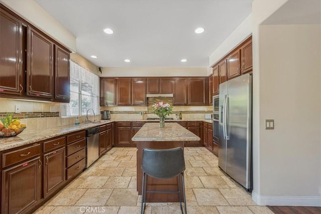 12614 Torrey Pine Rd, Moreno Valley, CA 92555 - kitchen featuring stainless steel appliances, a center island, stone tile floors, decorative backsplash, and recessed lighting