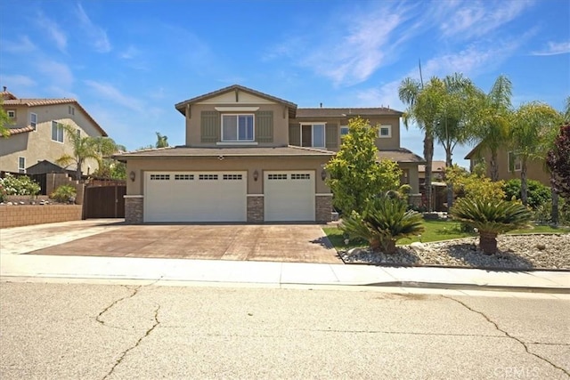 12614 Torrey Pine Rd, Moreno Valley, CA 92555 - view of front of house with an attached garage, stucco siding, driveway, and stone siding