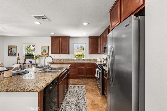 8090 Cornwall Ct Unit 33, Rancho Cucamonga, CA 91739 - kitchen featuring stainless steel appliances, a sink, recessed lighting, light stone counters, and a center island with sink