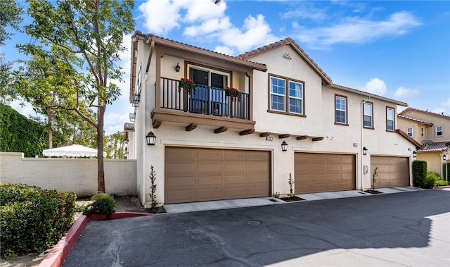 8090 Cornwall Ct Unit 33, Rancho Cucamonga, CA 91739 - view of front of house featuring an attached garage, stucco siding, and a balcony