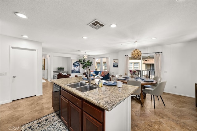 8090 Cornwall Ct Unit 33, Rancho Cucamonga, CA 91739 - kitchen featuring a sink, open floor plan, recessed lighting, a kitchen island with sink, and a textured ceiling