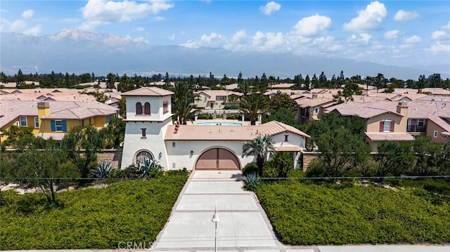 8090 Cornwall Ct Unit 33, Rancho Cucamonga, CA 91739 - mediterranean / spanish house featuring a residential view, concrete driveway, stucco siding, and a mountain view