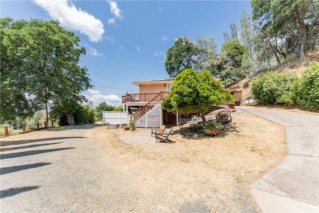 3788 Lakeview Ter, Lucerne, CA 95458 - obstructed view of property with stairway, a wooden deck, and gravel driveway