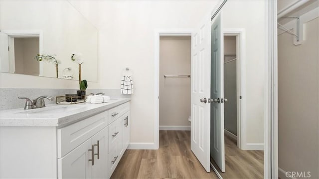 19029 Pires Ave, Cerritos, CA 90703 - bathroom with wood finished floors, vanity, and baseboards