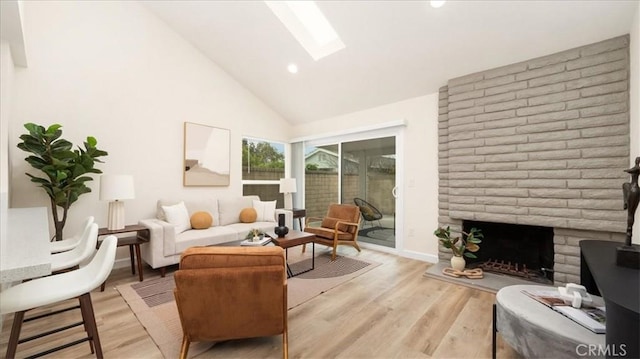 19029 Pires Ave, Cerritos, CA 90703 - living area featuring a skylight, light wood finished floors, high vaulted ceiling, a fireplace, and recessed lighting