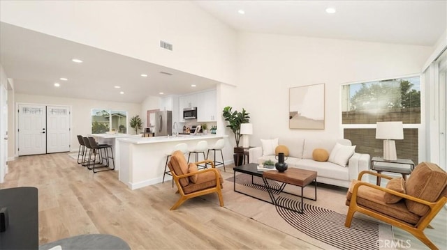 19029 Pires Ave, Cerritos, CA 90703 - living area with light wood-type flooring, recessed lighting, and high vaulted ceiling