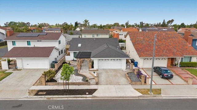 19029 Pires Ave, Cerritos, CA 90703 - view of front of property featuring a residential view, driveway, a garage, and roof mounted solar panels