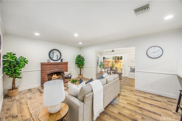 1456 Fernwood Dr, Redlands, CA 92374 - living room with recessed lighting, ornamental molding, light wood-type flooring, a brick fireplace, and a ceiling fan