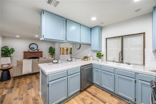 1456 Fernwood Dr, Redlands, CA 92374 - kitchen featuring dishwasher, a sink, blue cabinetry, a peninsula, and tile countertops