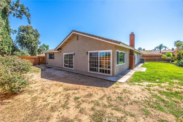 1456 Fernwood Dr, Redlands, CA 92374 - back of property featuring a chimney, stucco siding, and a patio area