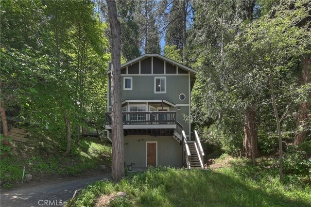 23819 Scenic Dr, Crestline, CA 92325 - rear view of house featuring stairway, a wooden deck, and driveway